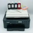 Katies Edible Ink Newest Model Canon Printer- Canon TS705A WiFi Printer - Super Clear Print Quality - Edible Ink Cartridges Included - 25 Sheets Of Premium Icing Sheets & Wafer Paper Included